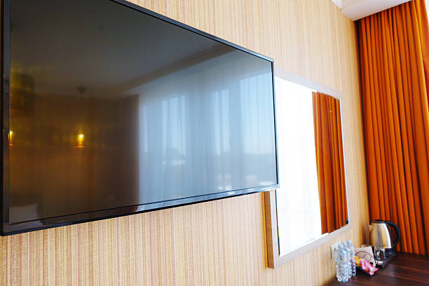 istock Modern hotel room featuring flat-screen TV and stylish decor 2208289046