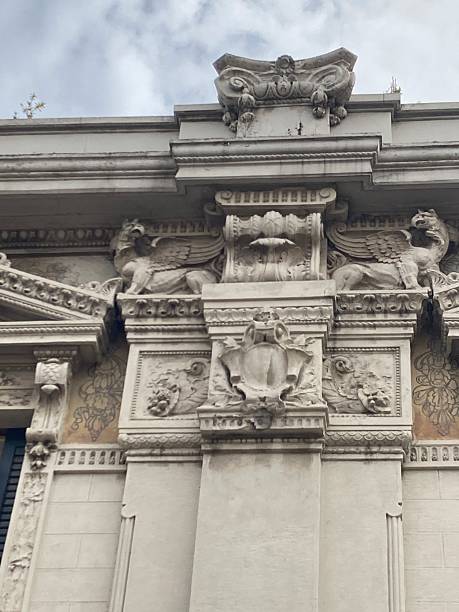 istock Decorated relief pillar with dolphin and dragon relief sculpture,  cartouche, decorated bracket, topped with doric organically decorated column. 2208292500
