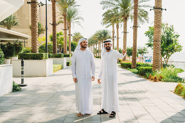Two arab businessmen walking and talking in Dubai