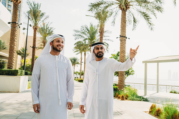 istock Two Arab businessmen walking and discussing in Dubai 2208295012
