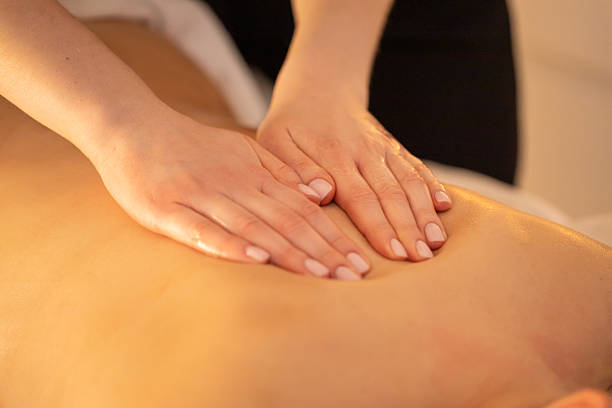 istock Massage therapist pressing hands along clients back during massage at the spa 2208295052