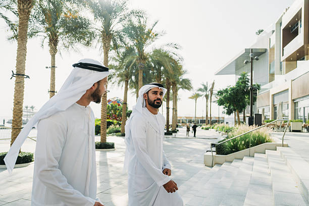 istock Emirati businessmen walking and talking in Dubai 2208295081