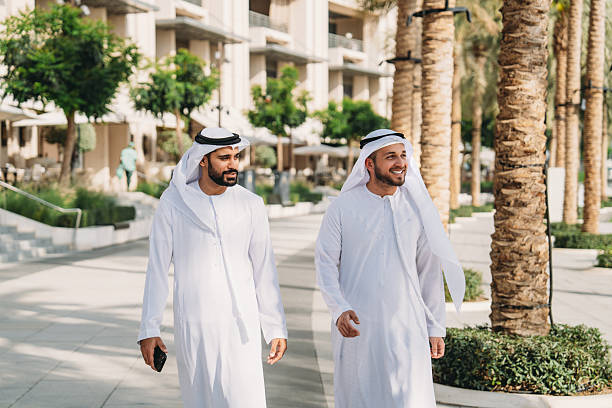 istock Two Arab businessmen walking and talking in Dubai 2208295082