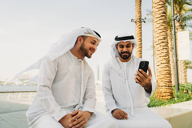 istock Two Arab businessmen looking at a smartphone in Dubai 2208295128