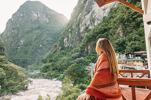 istock Woman Wrapped in Blanket Enjoying Mountain View from Balcony 2208297508