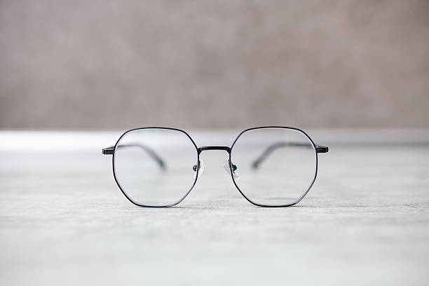 istock Close up of trendy polygonal glasses on grey background. 2208299852