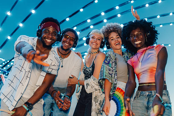 istock Happy friends dancing and enjoying silent disco at night 2208303898