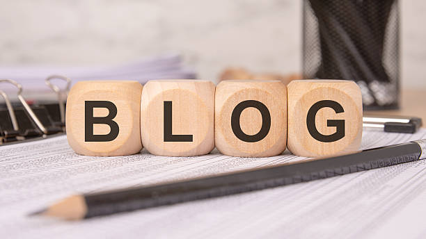 wooden blocks spelling BLOG on a desk, symbolizing content creation and online communication