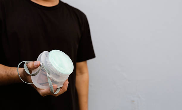 istock Man Holding N95 Mask for PM2.5 Protection Against Air Pollution 2208310289