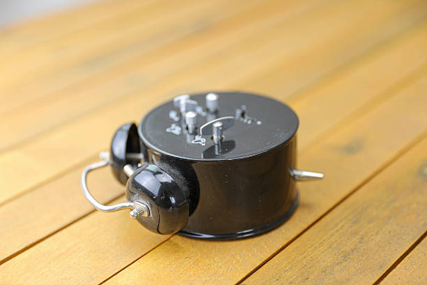 Old alarm clock on a wooden board.