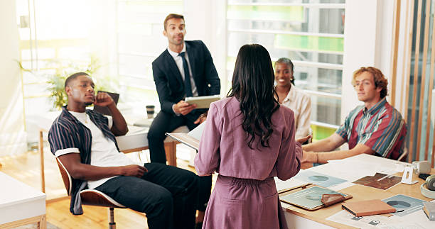 istock Professor, student and education speech in class for reading literature, studying and explain thesis. People, teacher and talking with book for learning notes, sharing knowledge and business course 2208314602