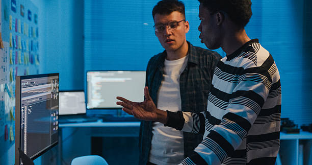 istock Diverse group of IT professionals blockchain technology and data security during business meeting, focused on innovation and coding in office at night. Artificial intelligence and programming 2208314971