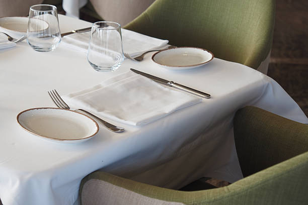 istock An Elegant Dining Table Setting Complemented by Stylish Green Accent Chairs 2208321840