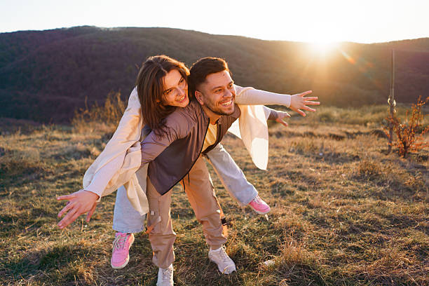istock Couple whit outstretched hands enjoying day on a mountain 2208326114