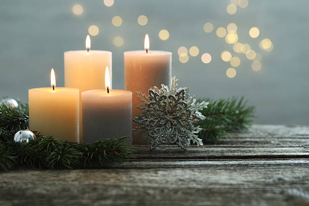 istock Burning candles, baubles and fir tree branches on wooden table, closeup. Space for text 2208326235