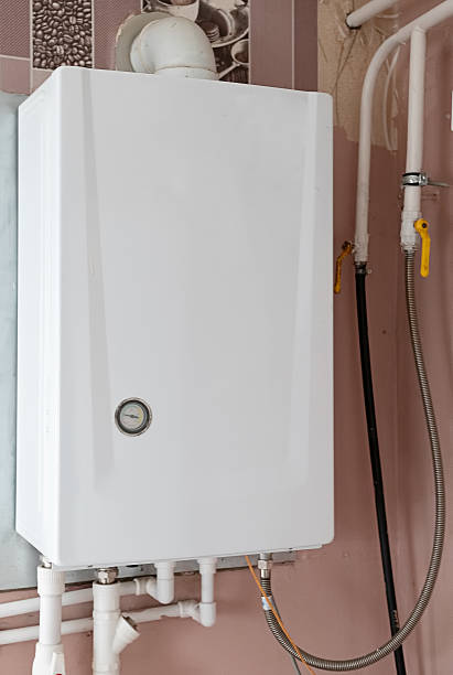 istock Heating boiler tank. Room with heating equipment. Gas boiler technologies. Heating system country house. Boiler tank at wooden wall. Gas equipment to maintain temperature. Engineering communications 2208327745