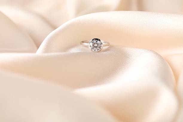 istock Beautiful ring with gemstone on beige fabric, closeup 2208328674