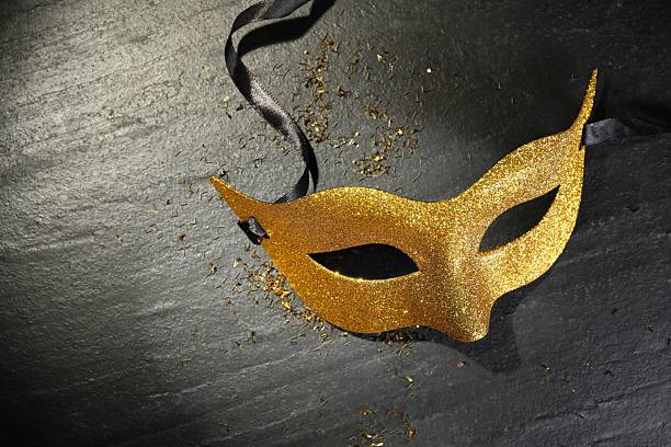 istock Beautiful golden carnival mask on grey textured table, top view 2208329288