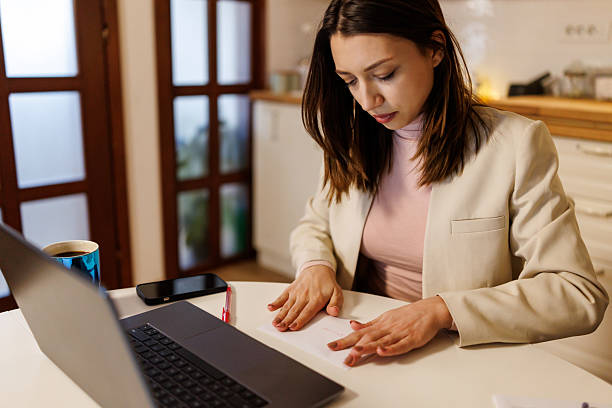 istock Prudent young woman saving money 2208333397