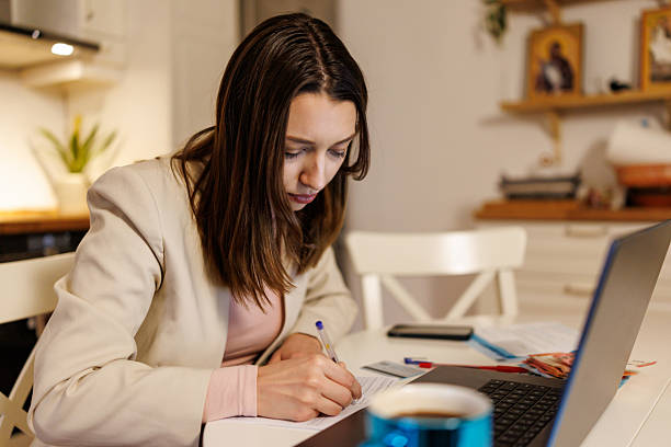 istock Young woman working on personal finances at home 2208333591