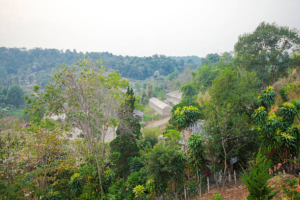 View into landscape around rural thai town  in upnorthern Thailand at late afternoon in mountain area of Chiang Mai province. Village is in area of Ban Pong.
