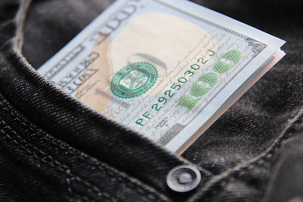 istock American dollars USD banknotes in jeans pocket. 2208336542