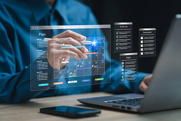 istock Project management, Calendar plan concept, Businesswomen use laptops prioritise planning of project control checklist highlighting key aspects, Teamwork, Cost management, Goal setting, risk assessment 2208338009