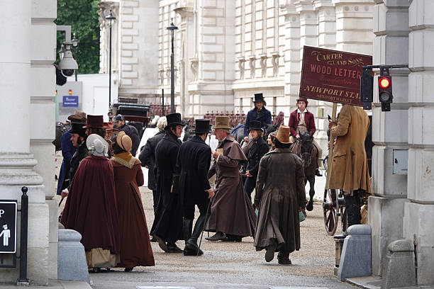 LONDON, UNITED KINGDOM, SEPTEMBER 14, 2023: Bustling film set scene while filming a historic drama with actors and crew in the midst of production. Vintage movie production scene in centre of London.