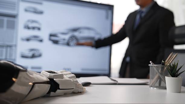 istock Businessman Working with Robotic Hand and Car Design on Digital Screen 2208342141