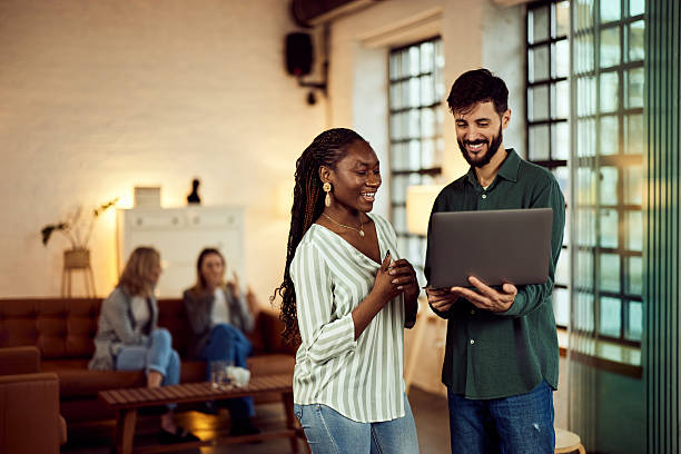 istock Coworkers Collaborating on a Laptop in a Modern Comfortable Office Space 2208343954