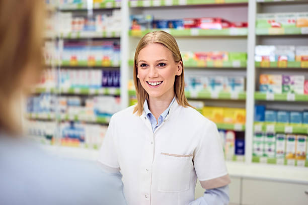 istock Friendly Pharmacist Assisting Customers in a Modern Pharmacy Environment 2208345485