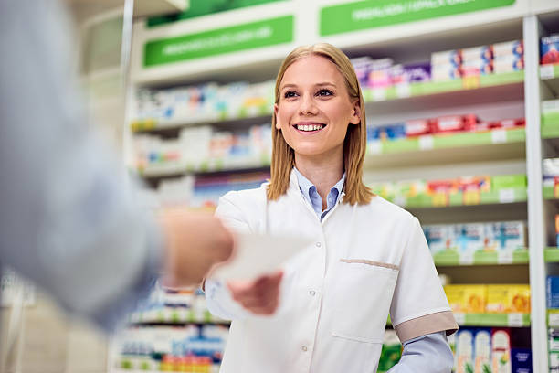 istock Smiling Pharmacist Assisting Customer in Modern Pharmaceutic Store 2208345489