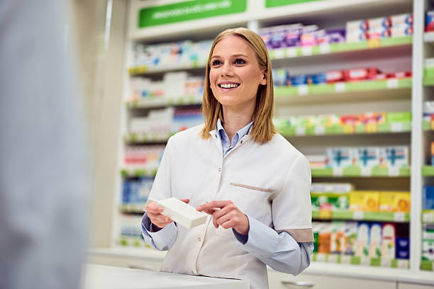 istock Smiling Female Pharmacist Assisting Customer in a Modern Pharmacy Setting 2208345502