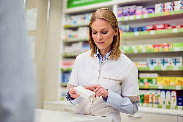 istock Pharmacist Assisting Customer in an Organized Pharmacy Store 2208345504