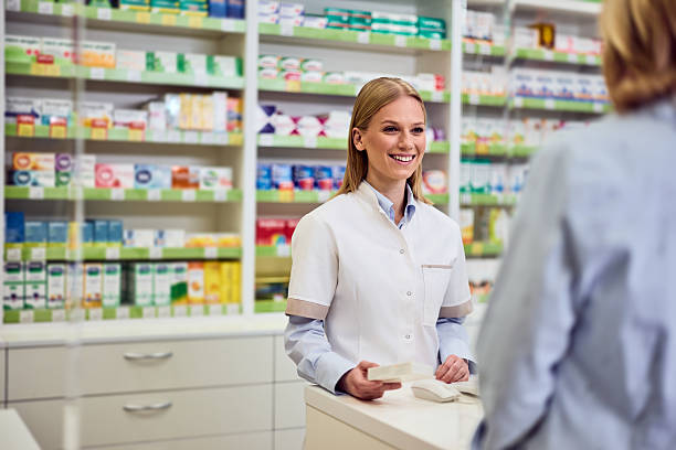 istock Smiling Pharmacist Assisting Customer in Bright Modern Pharmacy Interior 2208345505