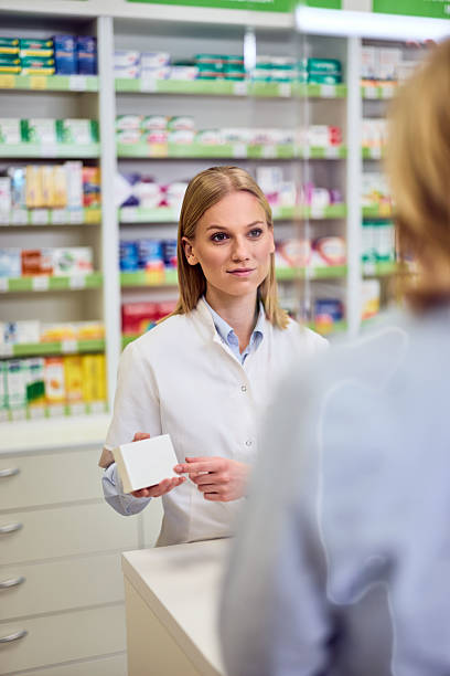 istock Pharmacist Assisting a Customer at a Pharmacy Counter With Medication 2208345506