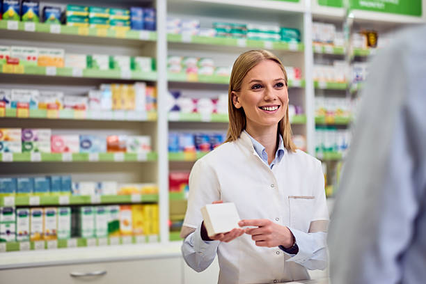 istock Friendly Pharmacist Assisting a Customer with Product Recommendation in a Pharmacy 2208345507