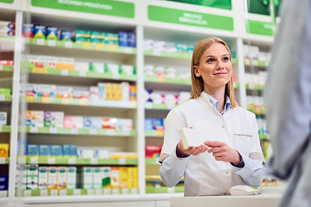 istock Pharmacist Assisting a Customer in a Modern Pharmacy Setting With a Smile 2208345511