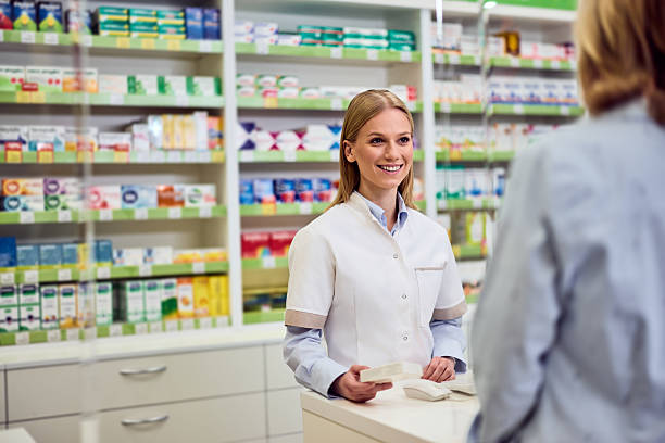 istock Smiling Pharmacist Assisting a Customer in a Modern Pharmacy Environment 2208345512