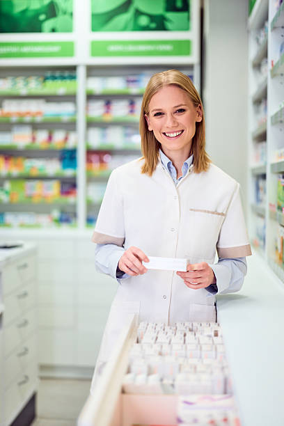 istock Portrait of Smiling Pharmacist Working in Modern Pharmacy Interior 2208345515