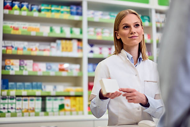 istock Pharmacist Assisting a Customer in a Modern, Well-Stocked Pharmacy Setting 2208345517