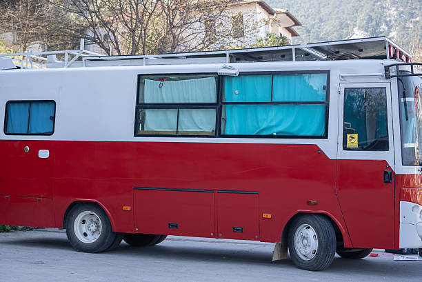 Red caravan bus in nature