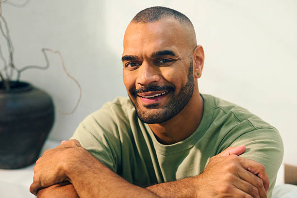 istock Young aboriginal australian man relaxing on sofa in the morning 2208354292