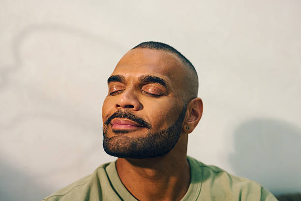 istock Young aboriginal australian man relaxing in the morning light 2208354298