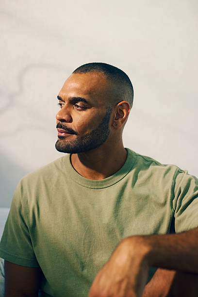 istock Young aboriginal australian man relaxing in the morning light 2208354303