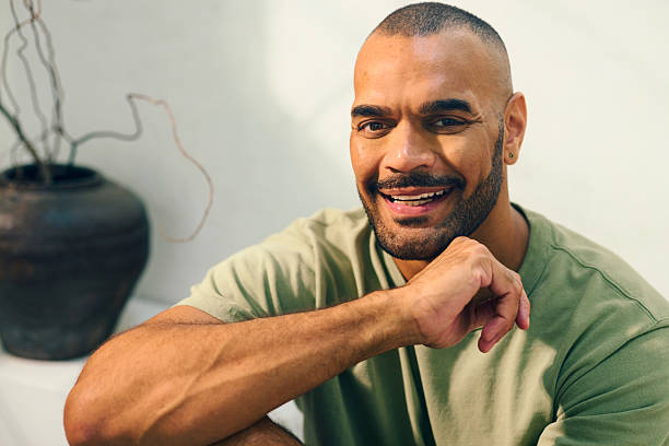 istock Young aboriginal australian man relaxing on sofa in the morning 2208354305