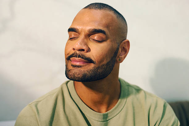 istock Young aboriginal australian man relaxing in the morning light 2208354306
