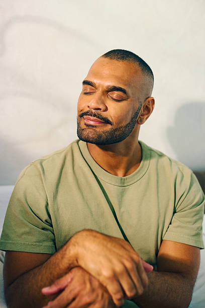 istock Young aboriginal australian man relaxing in the morning light 2208354327