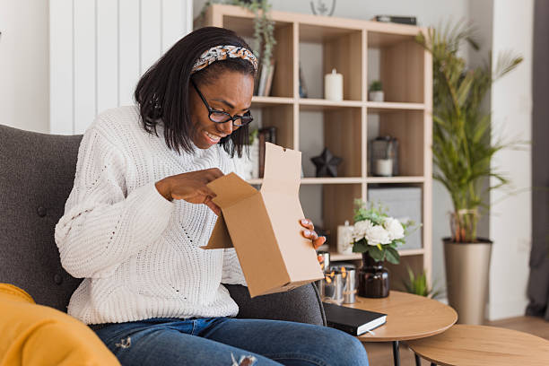 istock Happy woman peeking into a box 2208356254