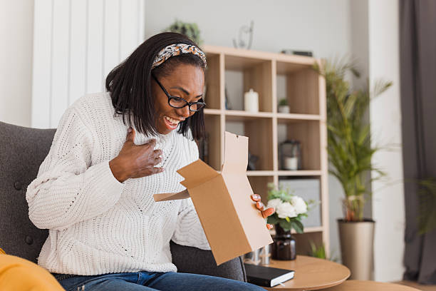 istock Surprised woman opening a box 2208356264